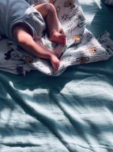 baby's legs on a bed