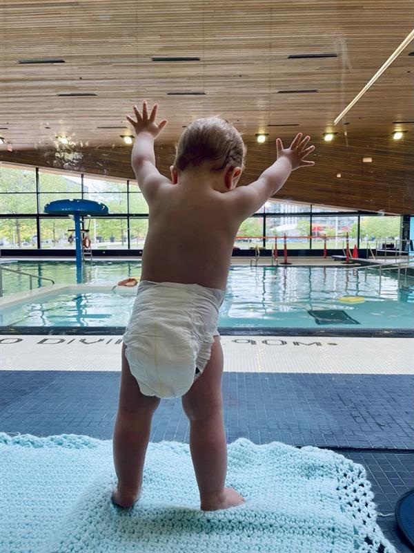 Baby wearing a diaper in a community swimming pool